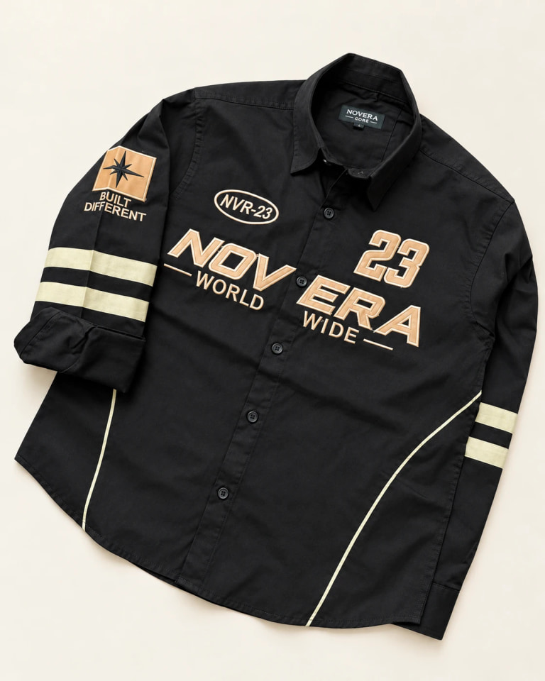 Tan applique and embroidery on our black varsity shirt sample
